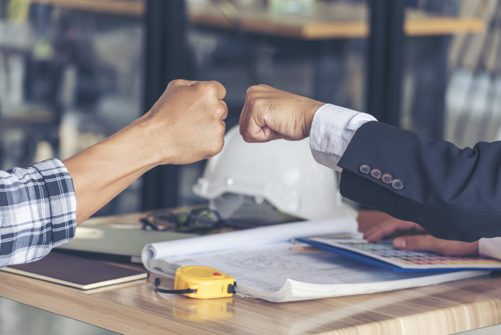 two men fist bumping